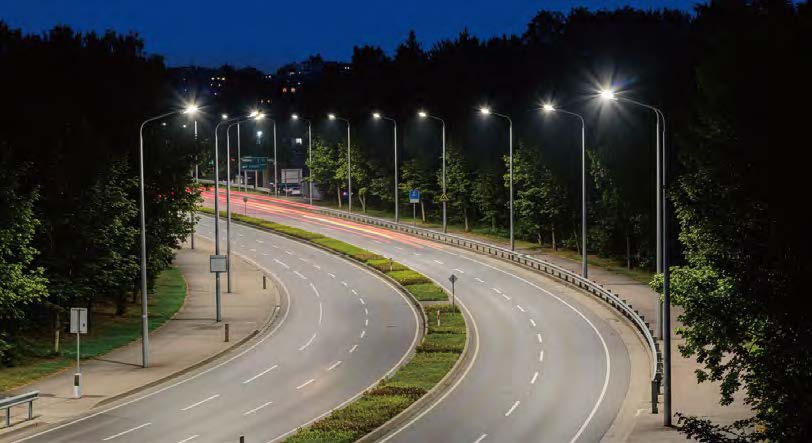 Road and street lighting illuminating a curved roadway