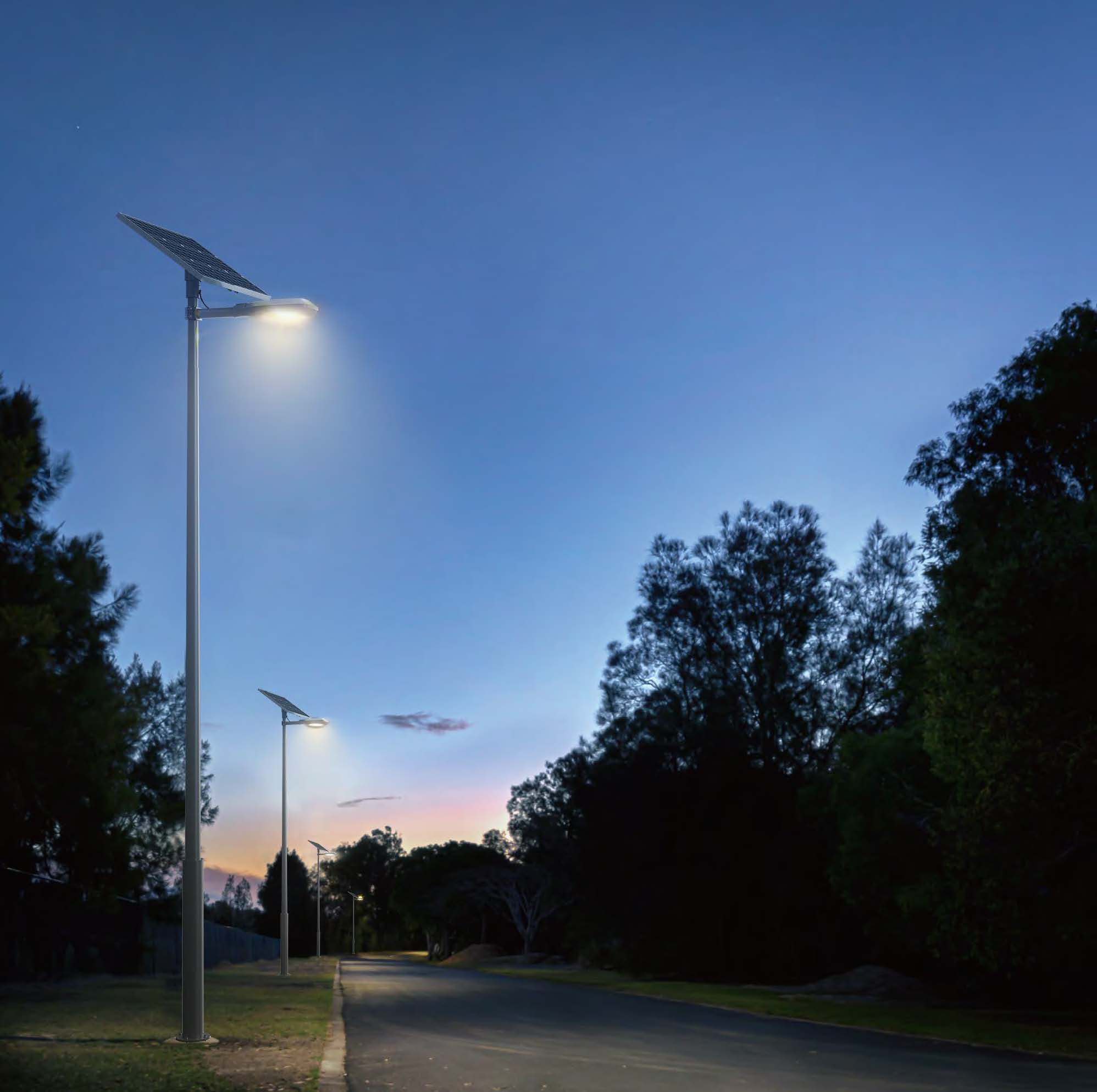 Pole-mounted solar luminaire on an outdoor path at dusk